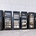 Black Kitchen Storage Appliances With Dishes Bowls In Row Light Colored Walls Floor