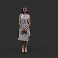 Stylish Woman In Patterned Sleeveless Dress Holding Beige Handbag Standing Against Black Background