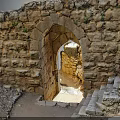 Ancient Stone Ruins With Arched Doorway Steps Pathway And Greenery