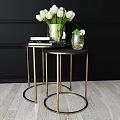 Round Dining Tables with Gold Legs Black Tabletop Decorated by White Tulips Books and Mint