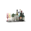 Assorted Wine Bottles And Glasses On Marble Tray With Green Plant Decoration