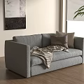 Gray Two Seater Sofa with Pillows and Blanket on Wooden Floor near Window with Plant