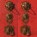 Golden Lion Head Door Knockers With Traditional Design On Red Background