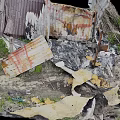 Broken Old Weathered Wooden Planks And Metal Sheets In Ash Debris With Overgrown Grass
