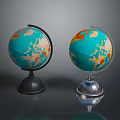 Two Globes With Black And Silver Bases Blue Ocean And Colored Continents On Gray Background