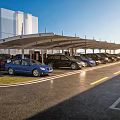 Modern Parking Lot With Canopy Structure Parked Cars And Modern Building