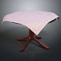 Patterned Light Colored Tablecloth On Round Wooden Leg Table For Home Use