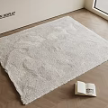 Fluffy Light Beige Square Rug on Wooden Floor with Open Book and Television