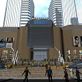 Modern Shopping Mall Atrium With Multi Level Glass Railings Bright Lighting And Polished Floors