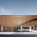 Modern Sales Office Building With Curved Metal Facade Glass Curtain Wall And Water Reflection