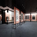 Cultural Center Interior With Traditional Paintings On Black Metal Display Stands And Red Walls