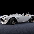 White Convertible Sports Car With Black Racing Stripes And Large Alloy Wheels