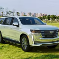 Modern Sleek SUV Parked On Green Grass Field With Natural Surroundings And City View