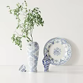 Elegant Blue and White Patterned Vase With Green Foliage Decorative Plate And Ornament