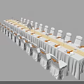 Elegant Banquet Table Setup With White Tablecloth Yellow Sashes And White Chairs
