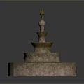 Ornamental Multi Tiered Stone Fountain Featuring Textured Base And Decorative Spire