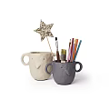 Elephant Shaped Beige And Gray Mugs With Brush Colored Pencils And Star Decoration