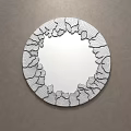 Round Mirror With Black Cracked Frame Reflects Bedroom Bed And Pillows