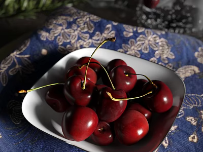 Deep red cherries in white plate on blue patterned cloth 3d model