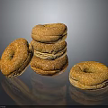 Golden Brown Sesame Seed Bagels Stacked and Single on Black Surface