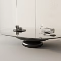 Modern Round Glass Top Coffee Table With Black Base And Decorative Books And Glasses
