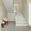 Minimalist Storefront Facade Design With White Wall Staircase Entrance Signboard And Side Plant