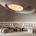 Curved Beige Sofa and Coffee Table Set with Decorative Items in Modern Living Room
