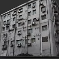 Old Weathered Residential Building Exterior With Multiple Air Conditioners And Windows