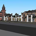 Red Brick Commercial Complex With Clock Tower And Multiple Storefront Buildings