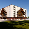 Modern Multi Story Building With Traditional Roof Elements White Facade Wooden Base And Lawn
