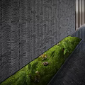 Small Garden Feature with Green Moss Ferns Stones and Wavy Textured Wall on Dark Floor