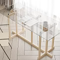 Stylish Glass Top Wooden Desk Featuring Cross Leg Design Open Magazine White Coffee Cup