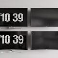 Four Televisions on White Wall with Some Screens Showing Time and Others Blank
