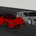 Red and Gray Sports Cars Parked Side by Side on Open Road