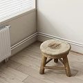 Wooden Stool With Round Worn Seat Crossed Legs Near White Radiator On Wooden Floor