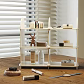 White Wooden Shelf with Skincare Products Deer Figurine and Boxes on Wooden Tabletop
