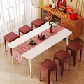 Six Red Stools Around White Table With Red Table Runner Fruit And Vase