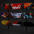 Three Colorful Snowboards With Vibrant Graphics Mounted On Black Rack For Sports Fitness