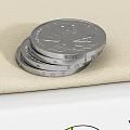 Two Silver Coins Stacked on Beige Fabric for Daily Living Supplies