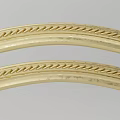 Elegant Golden Curved Decorative Strips Showcasing Intricate Braided Carving Design