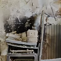 Fire Damaged Kitchen Interior Showing Burned Walls Broken Appliances And Debris