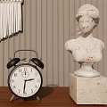 Black Alarm Clock On Wooden Tabletop With Marble Bust Statue And Fringe Decoration