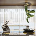 Modern Stone Sculpture With Twisted Green Plant Art And Water Basin In Interior Space