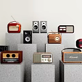Vintage Radios And Audio Devices Displayed On Gray Stands With Light Colored Walls