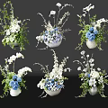 White And Blue Floral Arrangements In Decorative Vases With Green Leaves