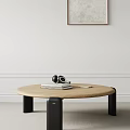 Modern Round Wooden Coffee Table With Black Headphones Stacked Books And Tablet