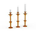 Three Orange Decorative Candle Holders With White Candles On White Background