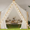 Café With White Tent String Lights Tables Chairs Green Plants And Grass Floor