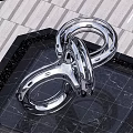Stainless Steel Infinity Symbol Sculpture in Urban Square with Black Base