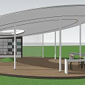 Modern Circular Pergola With White Pillars Wooden Floor And Curved Table Chairs On Green Lawn
